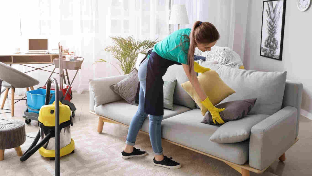 Cleaner wiping surfaces during transparent apartment cleaning services cost session