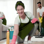 Professional team performing deep cleaning for apartment kitchen sanitization