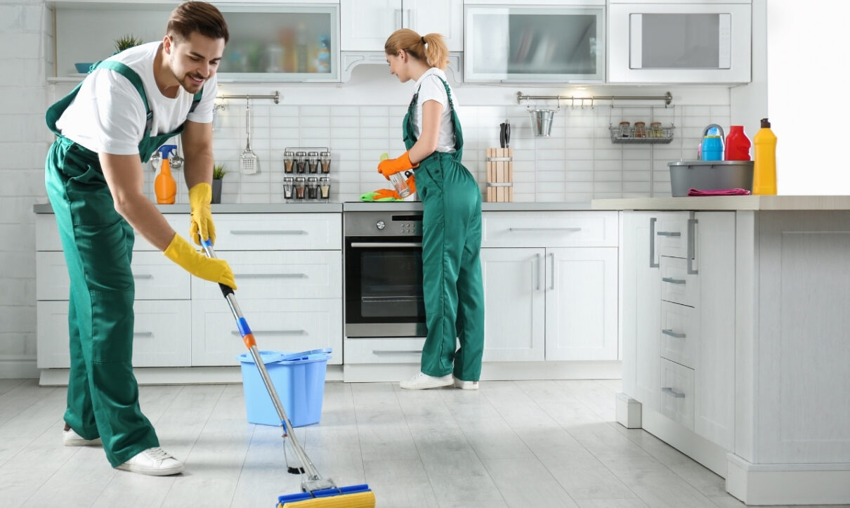 Professional team from apartment cleaning company cleaning living room in Al Shamkha