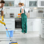 Professional team from apartment cleaning company cleaning living room in Al Shamkha