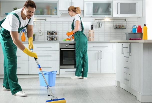 Professional team from apartment cleaning company cleaning living room in Al Shamkha