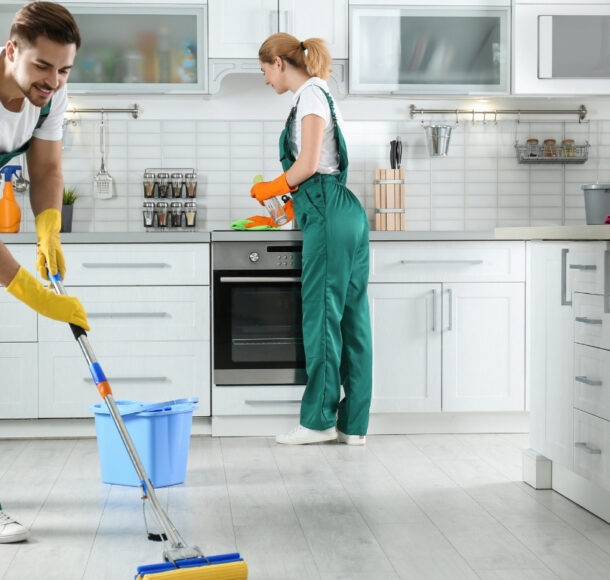 Professional team from apartment cleaning company cleaning living room in Al Shamkha