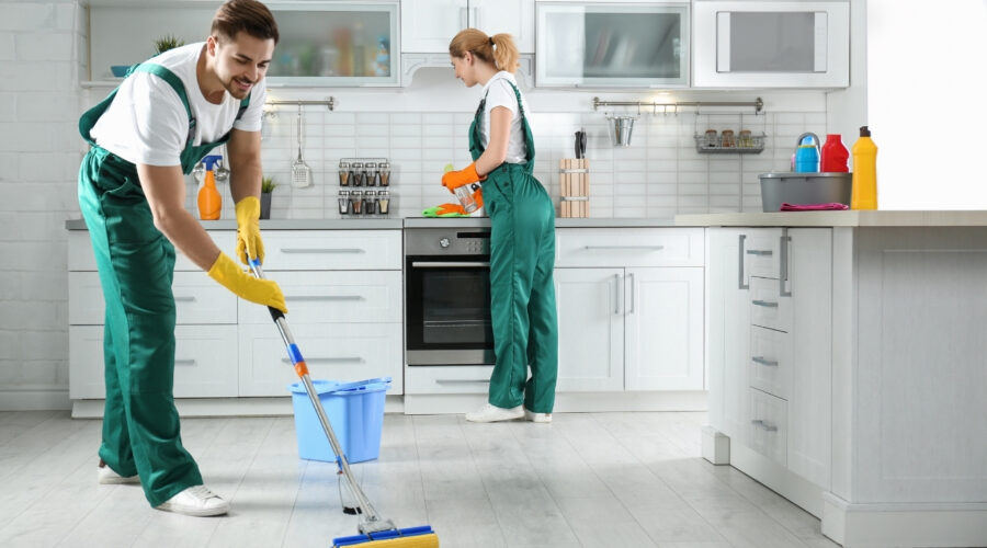 Professional team from apartment cleaning company cleaning living room in Al Shamkha